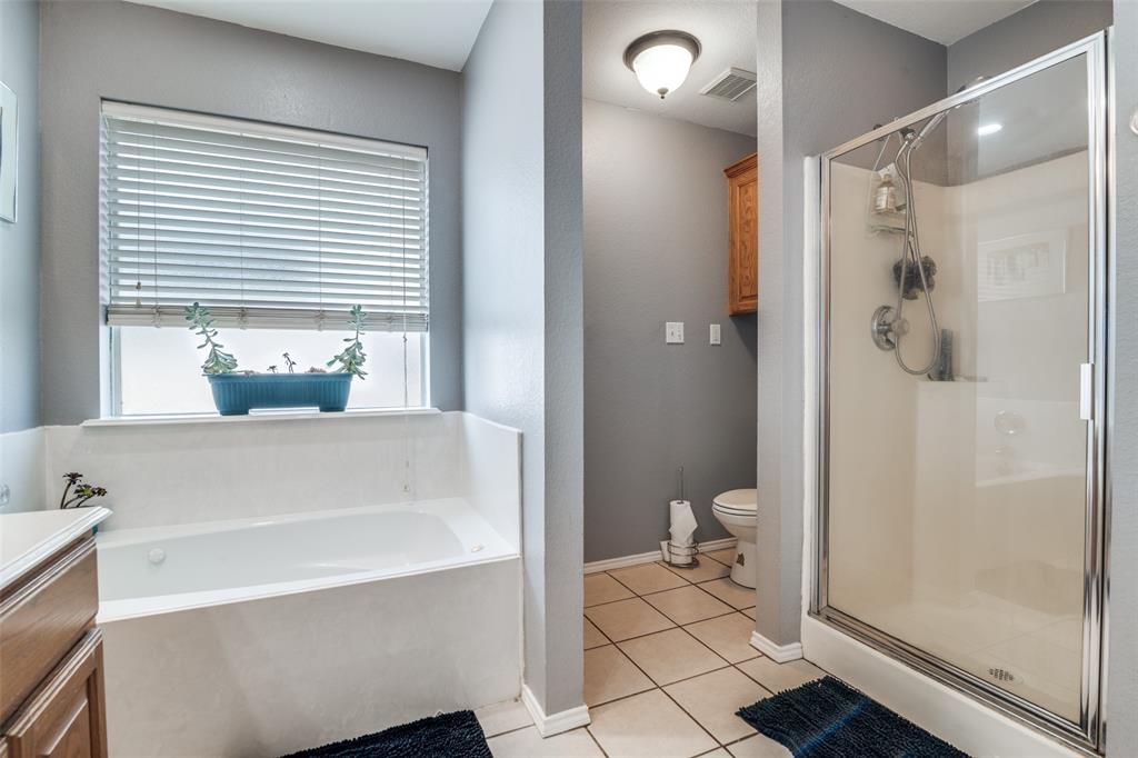 2900 County Road 643 Nevada, TX 75173 - Photo 31 of 36 a bathroom with a bathtub and a shower