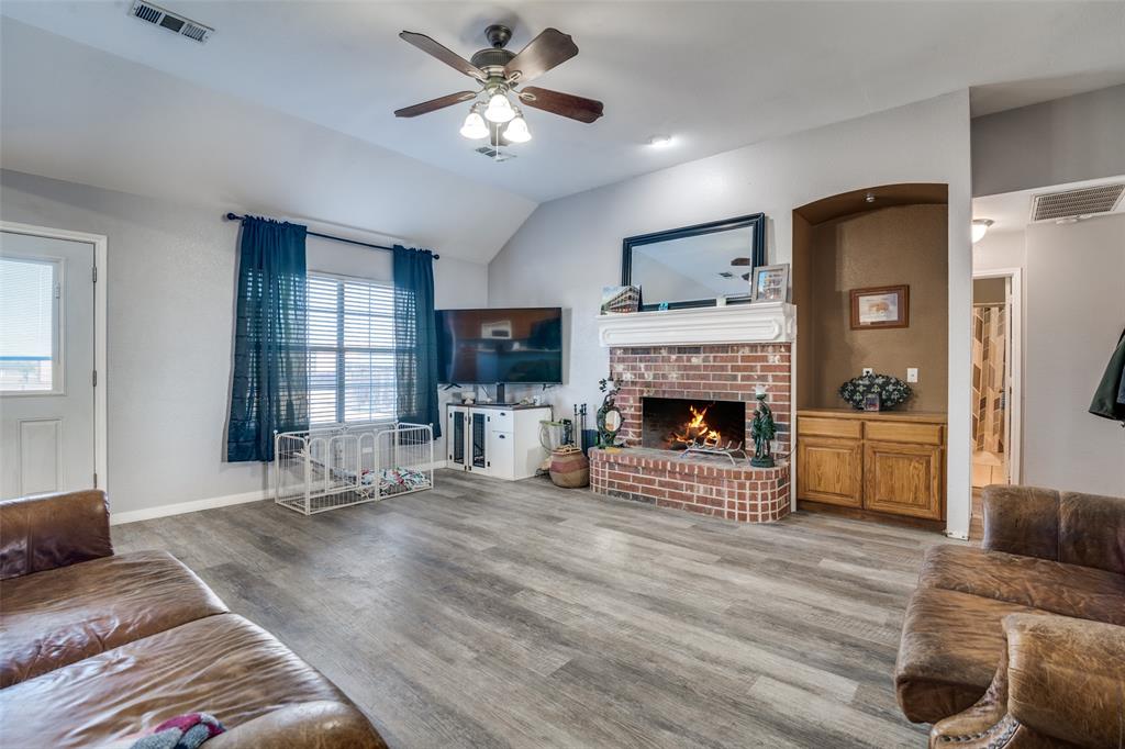 2900 County Road 643 Nevada, TX 75173 - Photo 9 of 36 a living room with furniture a fireplace and a flat screen tv