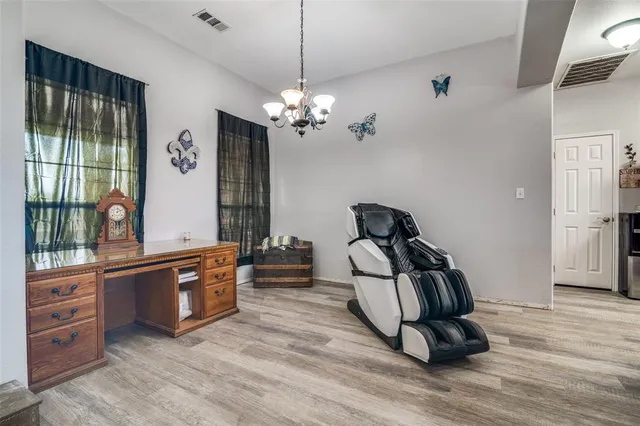 a workspace with wooden floor and furniture