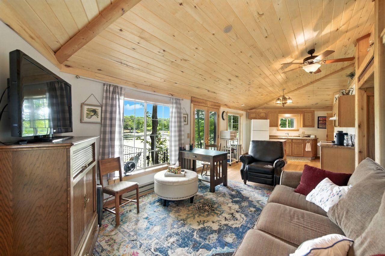 10570 Eagle Lake Road Delta, WI 54847 - Photo 6 of 24 Living room with vaulted ceiling, wood ceiling, light wood-style floors, french doors, and ceiling fan