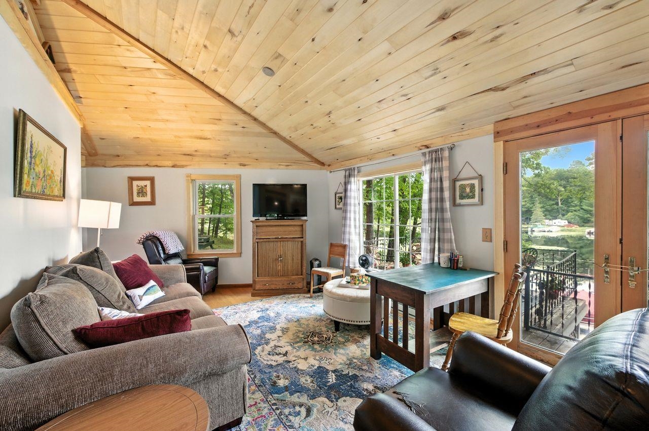 10570 Eagle Lake Road Delta, WI 54847 - Photo 7 of 24 Living room featuring wood ceiling, lofted ceiling, and wood finished floors