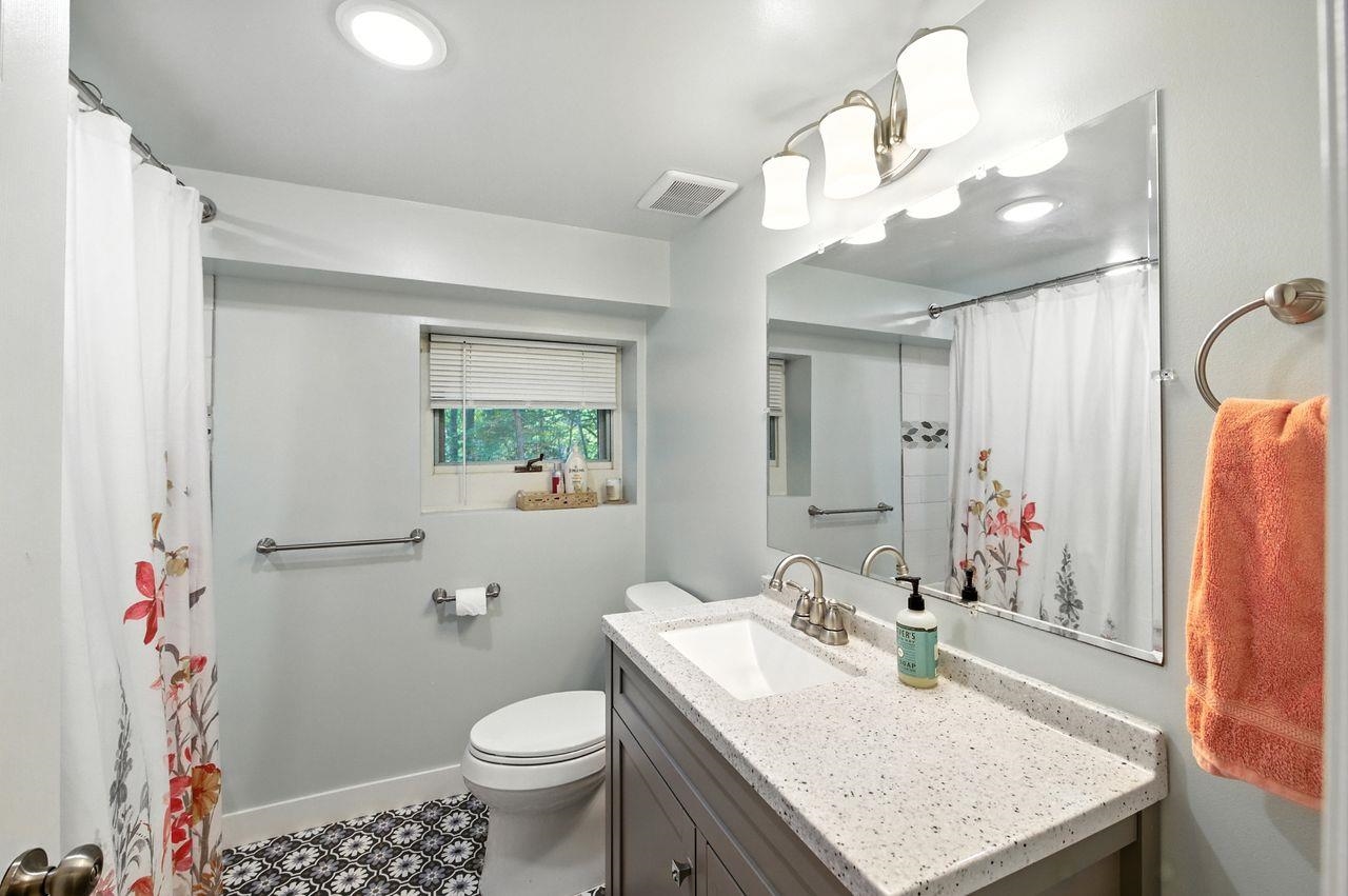 10570 Eagle Lake Road Delta, WI 54847 - Photo 10 of 24 Full bathroom with vanity and curtained shower