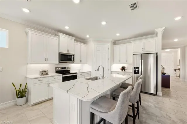 a kitchen with a table chairs refrigerator and microwave