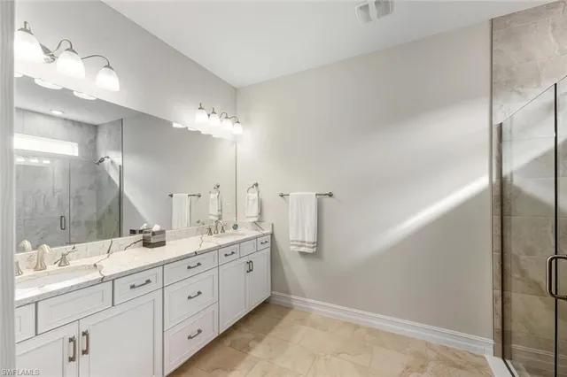 a bedroom with a bed a table and painting