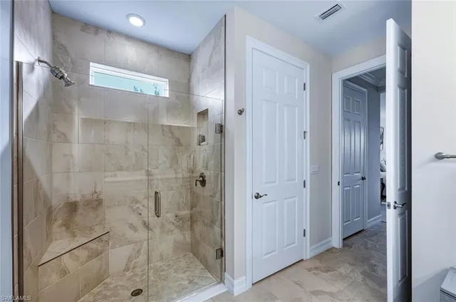 a bedroom with a bed and mirror on dresser