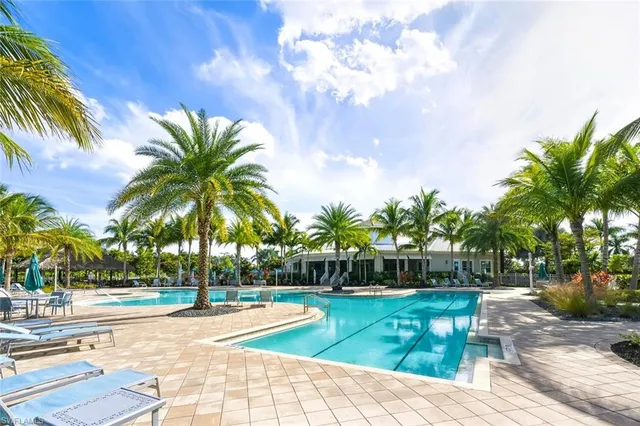 a view of a yard with swimming pool and sitting area