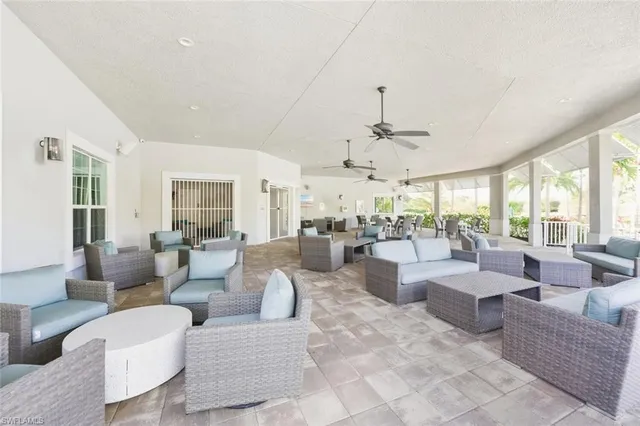 a living room with fireplace furniture and a large window
