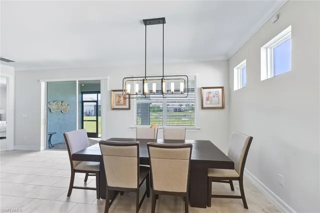 a dining room with furniture a chandelier and wooden floor