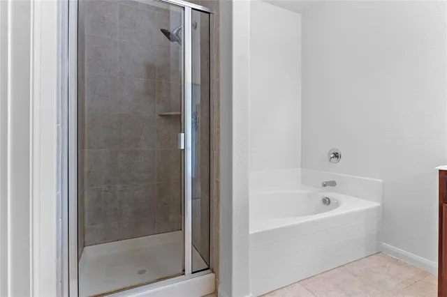a white bath tub sitting next to a shower