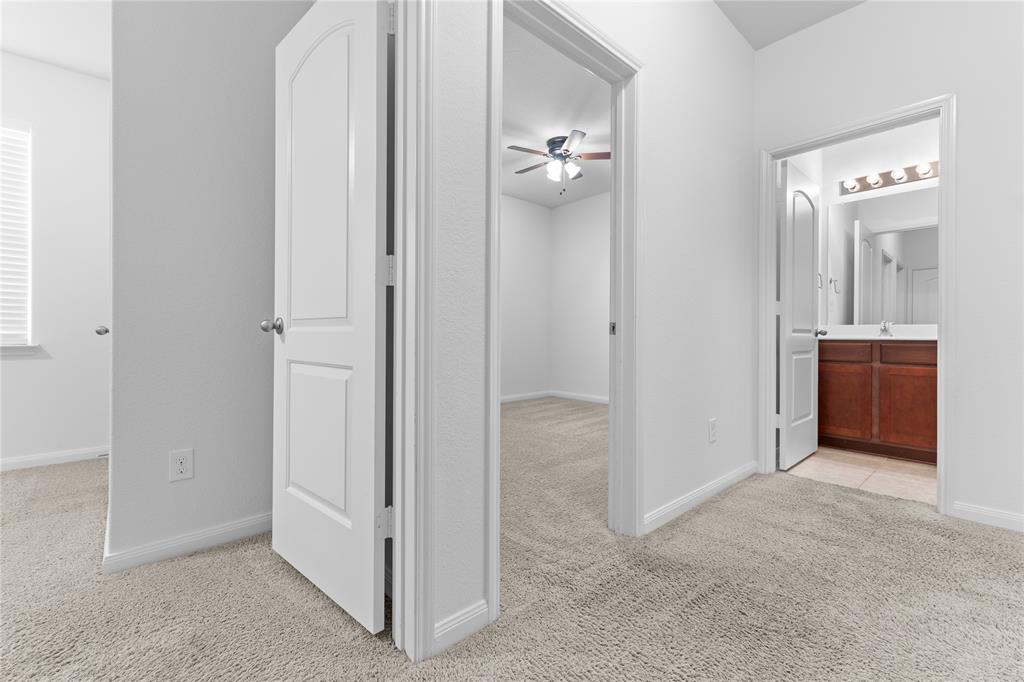 1815 Hot Springs Way Princeton, TX 75407 - Photo 14 of 22 an empty room with mirror and a bathroom