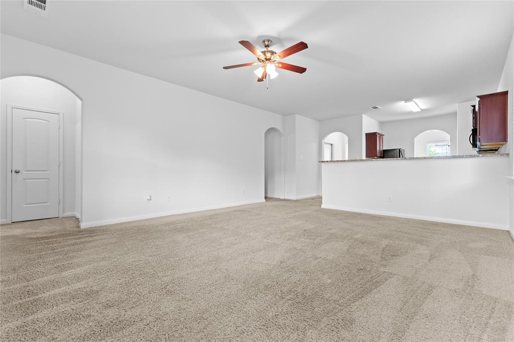 1815 Hot Springs Way Princeton, TX 75407 - Photo 17 of 22 a view of a livingroom with a ceiling fan and kitchen space