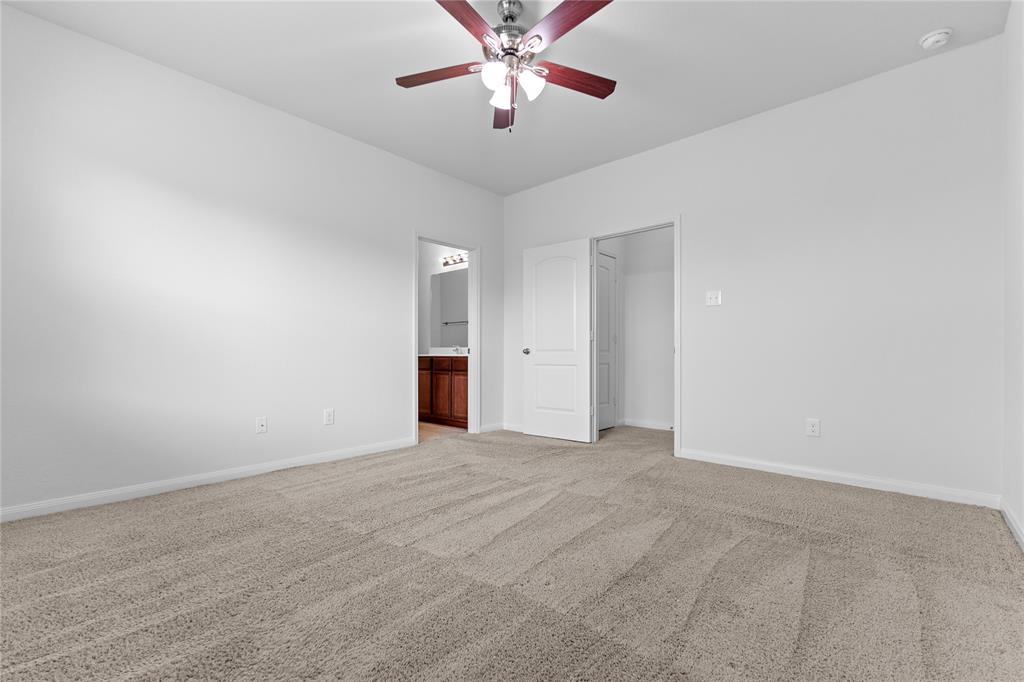 1815 Hot Springs Way Princeton, TX 75407 - Photo 19 of 22 an empty room with closet and a chandelier fan