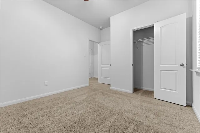 an empty room with closet area