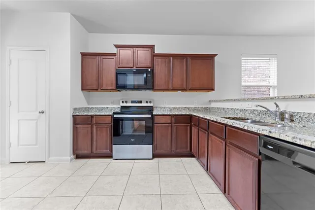 a kitchen with stainless steel appliances granite countertop a sink and cabinets
