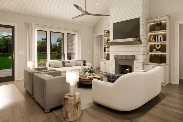 a living room with furniture a flat screen tv and a fireplace