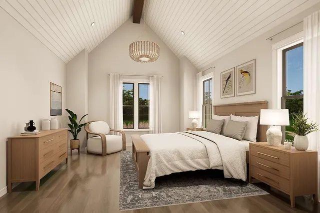 a bedroom with a large bed couch and windows