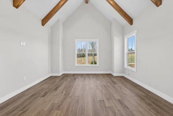 a kitchen with stainless steel appliances granite countertop a sink a stove and a wooden floor