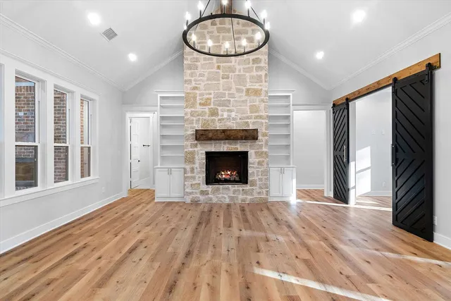 a view of kitchen with stainless steel appliances wooden floor and window