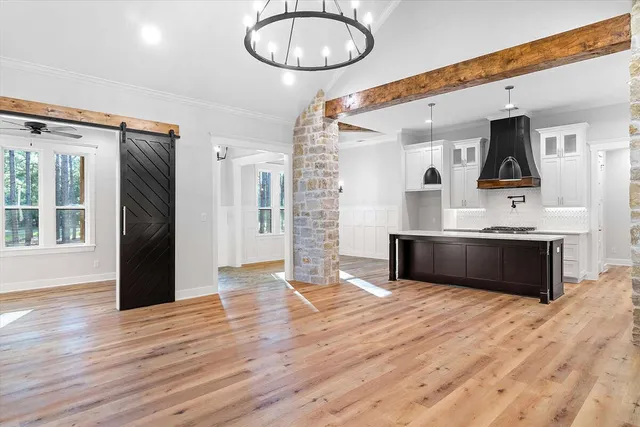a kitchen with a sink cabinets and wooden floor