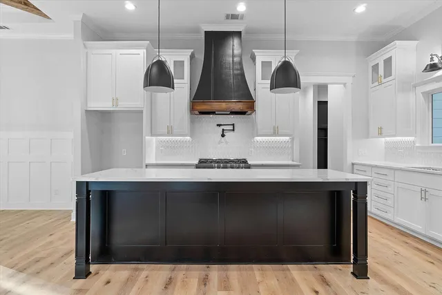 a kitchen with stainless steel appliances granite countertop a sink and stove