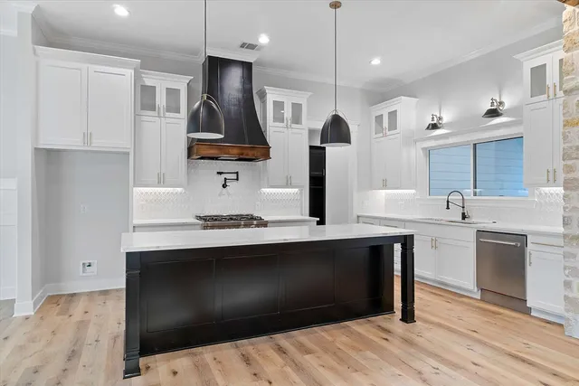 a kitchen with a sink and chandelier