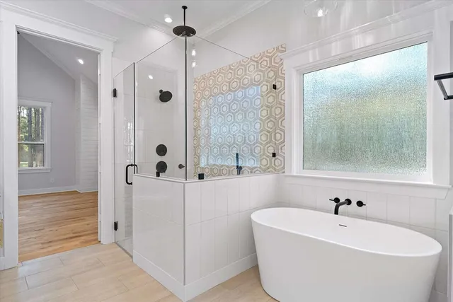 a view of a livingroom with wooden floor and a ceiling fan