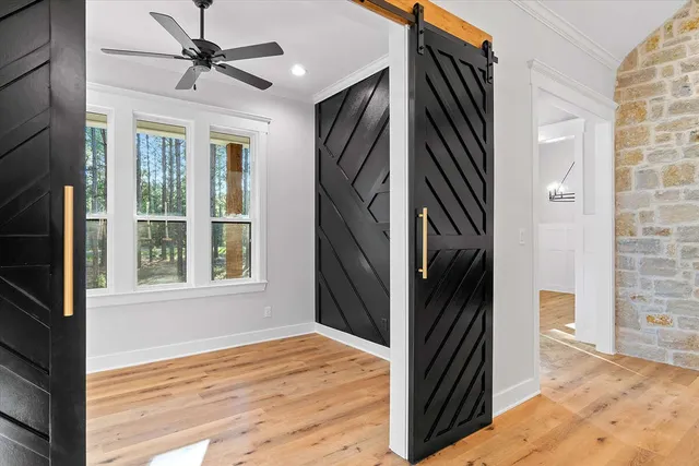 a view of a hallway with wooden floor and staircase