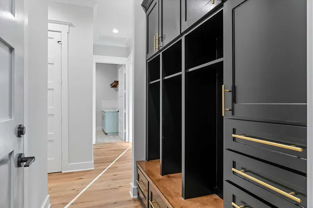 a bathroom with a window and cabinets
