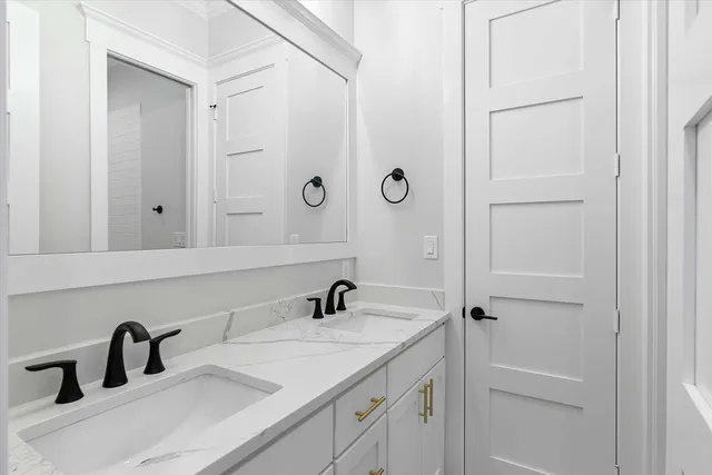 a bathroom with a granite countertop sink a toilet and a mirror