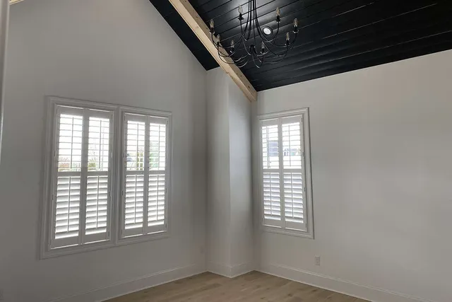 a spacious bathroom with a double vanity sink a mirror and a bathtub