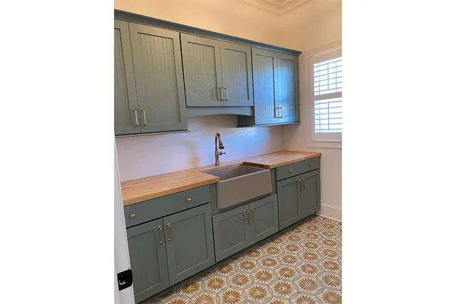 a living room with a flat screen tv and a wall painting