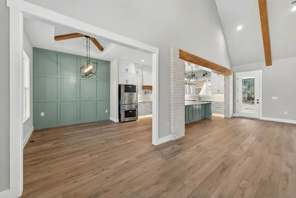 a living room with kitchen island granite countertop furniture and a fireplace