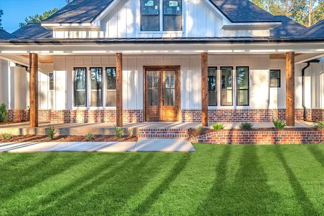 a view of a house with a yard patio and swimming pool
