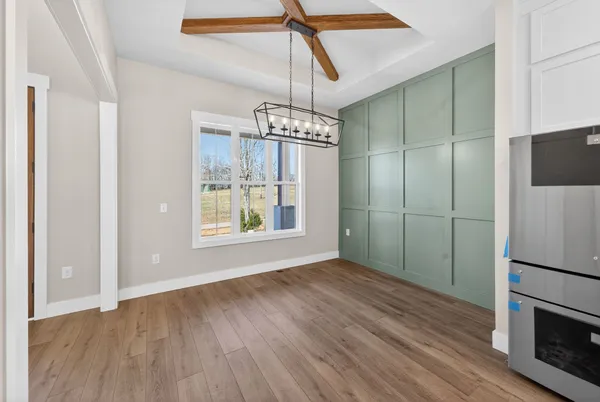 a view of a kitchen with stainless steel appliances granite countertop wooden cabinets a oven and a sink