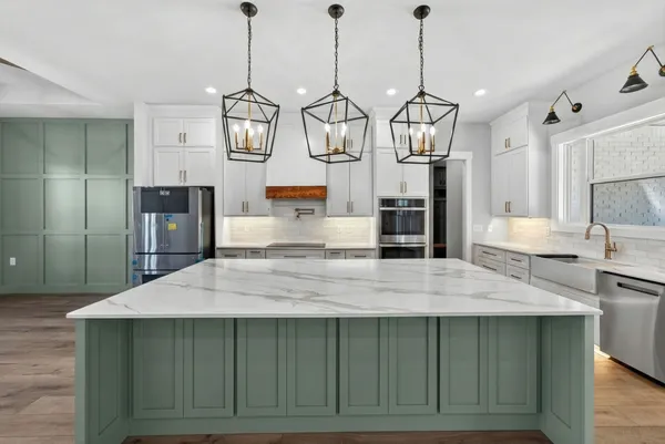 a kitchen with stainless steel appliances a refrigerator and cabinets