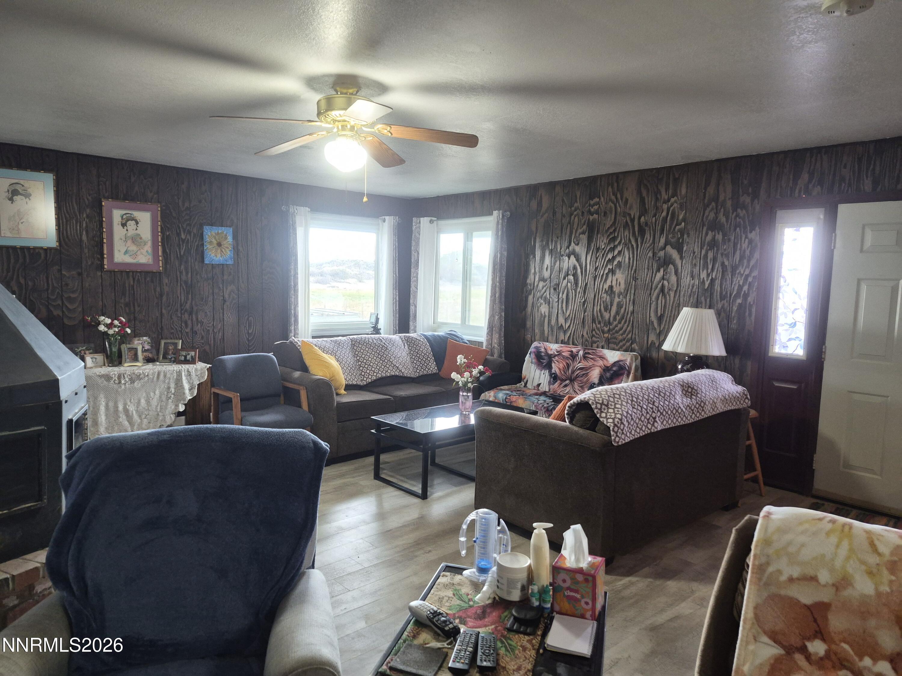 3280 Lone Tree Road Fallon, NV 89406 - Photo 33 of 59 a living room with furniture and a chandelier