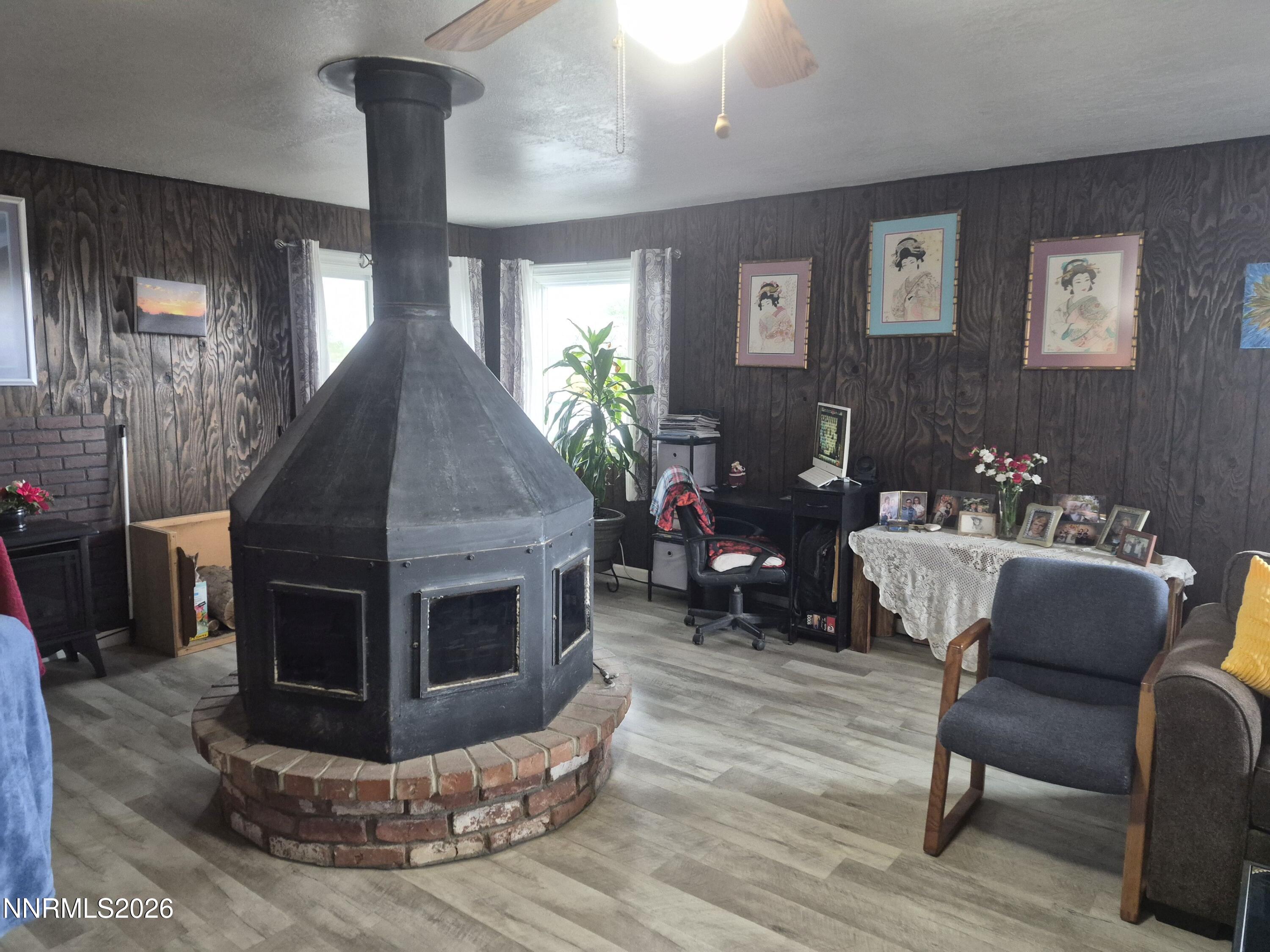 3280 Lone Tree Road Fallon, NV 89406 - Photo 34 of 59 a living room with furniture a fireplace and a flat screen tv
