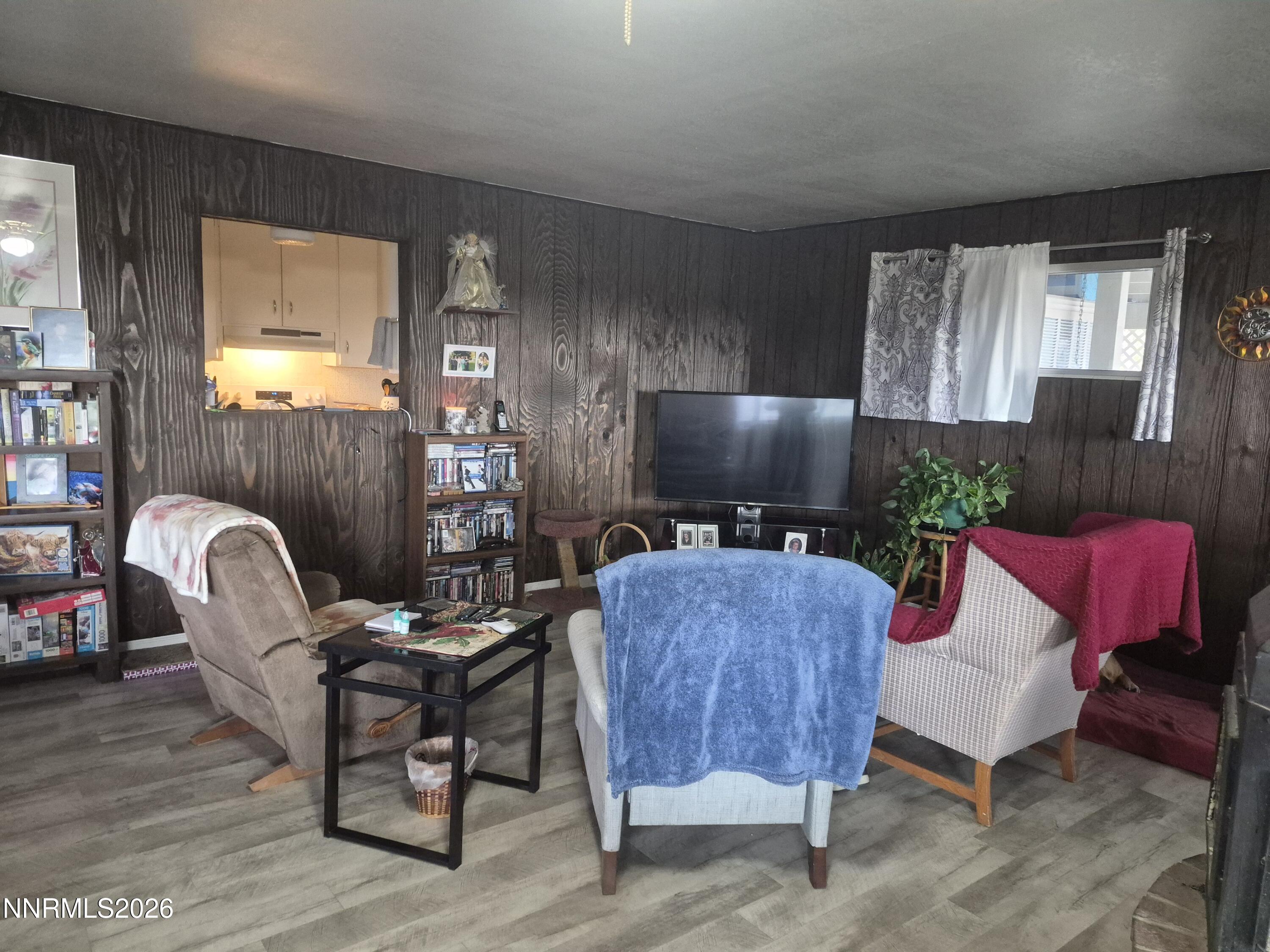 3280 Lone Tree Road Fallon, NV 89406 - Photo 35 of 59 a living room with furniture a large window and a flat screen tv