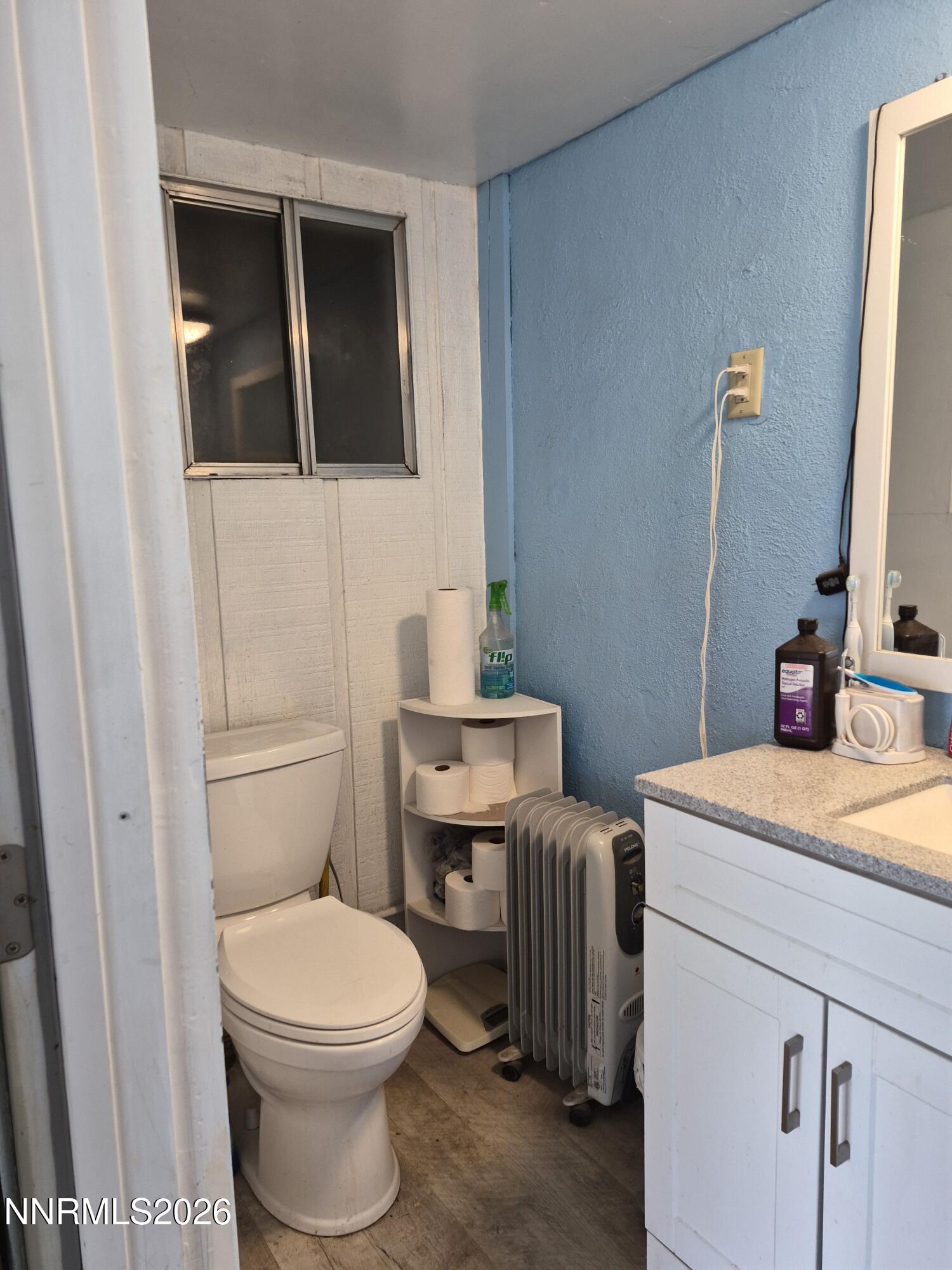 3280 Lone Tree Road Fallon, NV 89406 - Photo 57 of 59 a bathroom with a granite countertop toilet sink and mirror