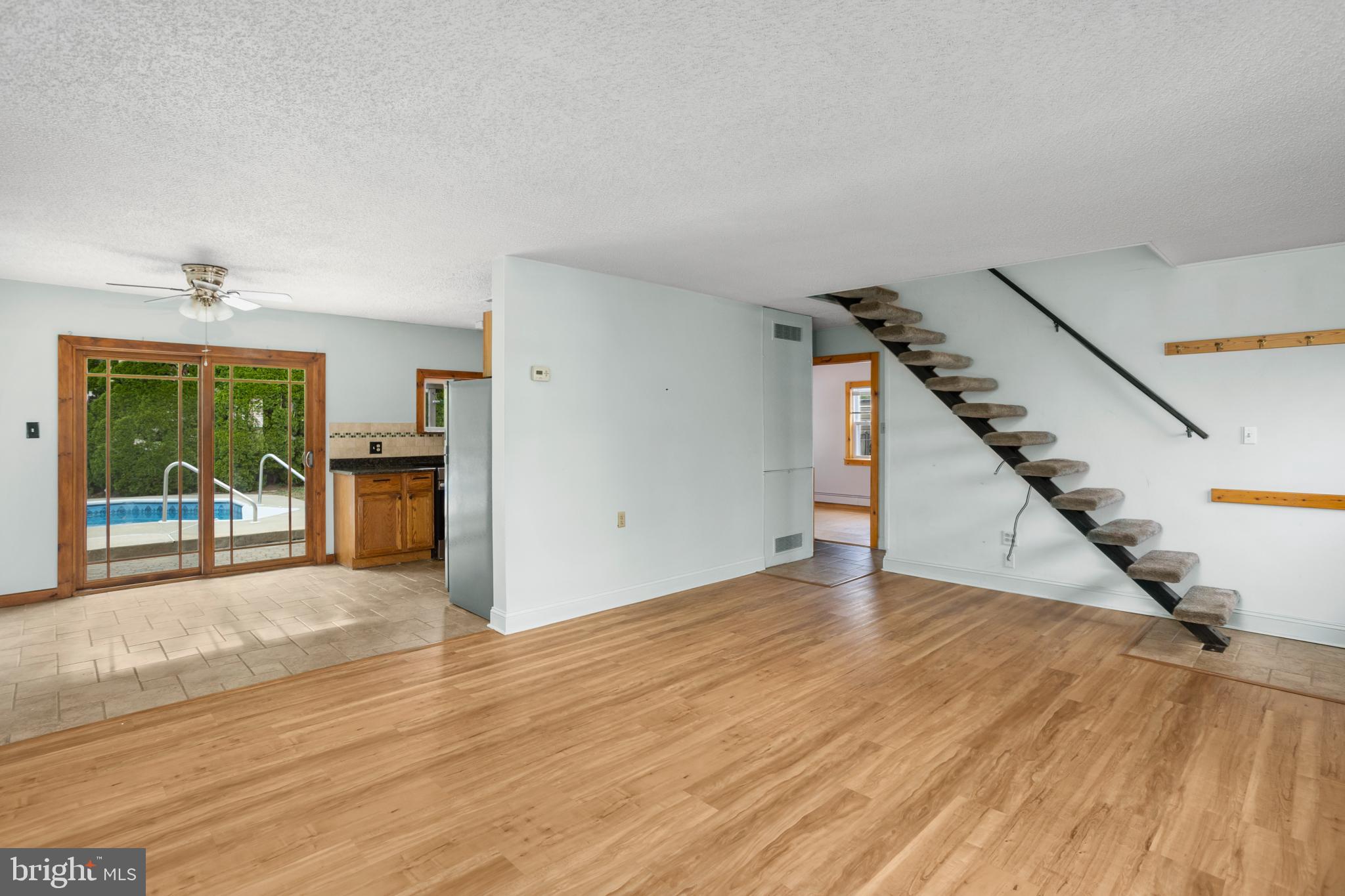 23 Cotton Road Levittown, PA 19057 - Photo 6 of 36 a view of an empty room with wooden floor and a window