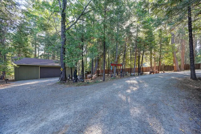 a view of backyard with outdoor seating and trees