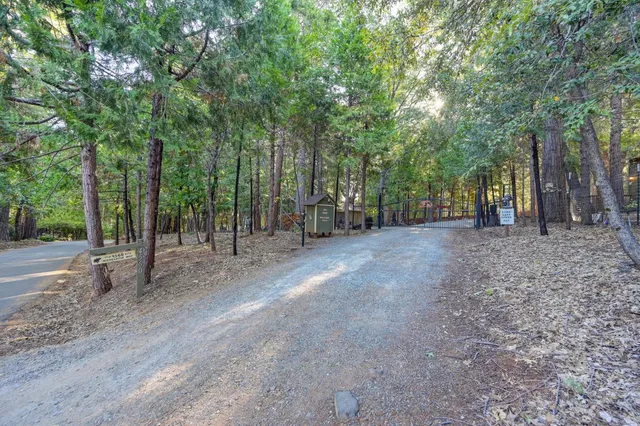 a view of a patio with table and chairs with wooden floor and fence