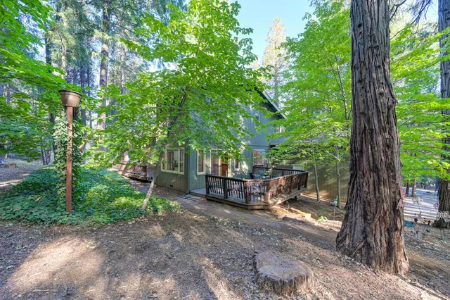 a view of a deck with a table and chairs with wooden floor and fence