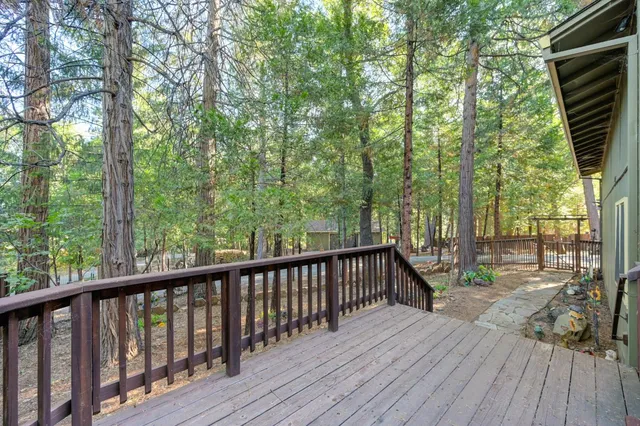 a view of a kitchen with kitchen island a sink wooden floor and a counter top space