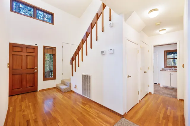 an empty room with closet and windows