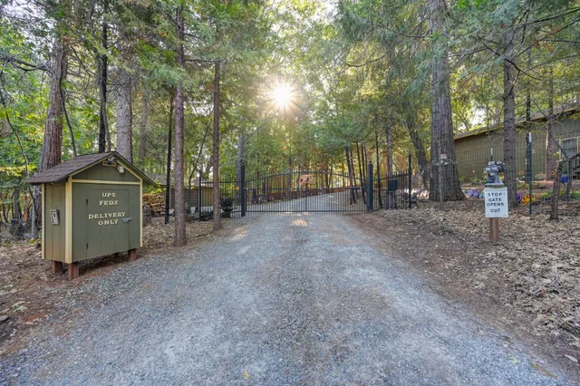 a view of a chair and table in backyard of the house
