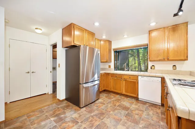 a bathroom with a double vanity sink a mirror and shower