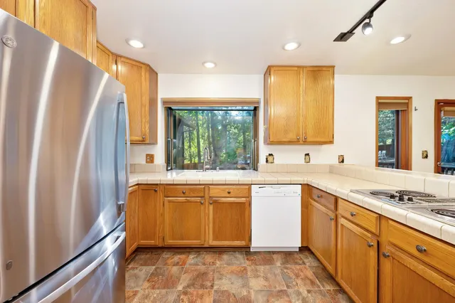 a backyard of a house with lots of green space and plants