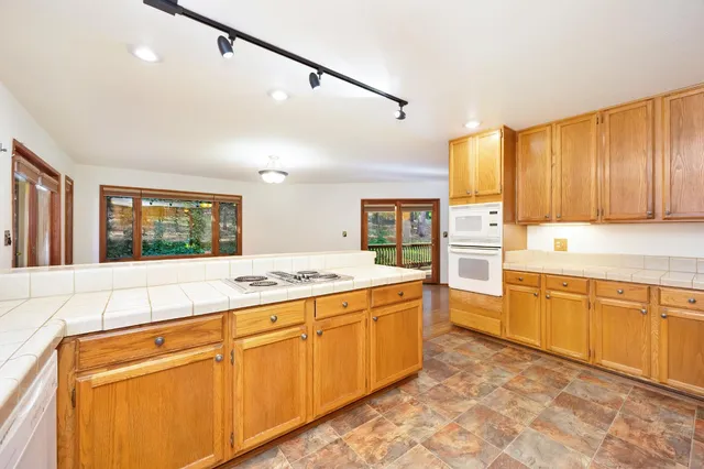 a view of backyard with deck and garden