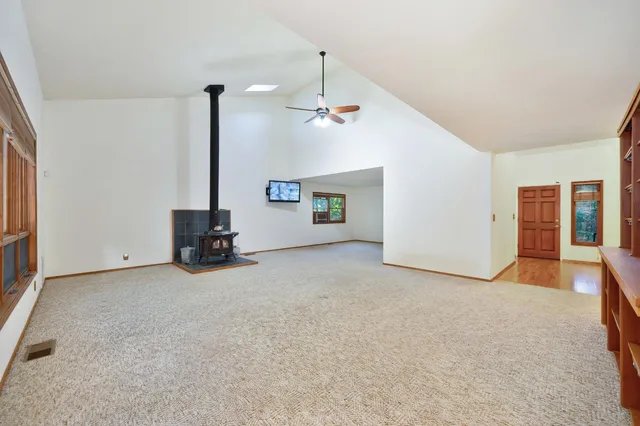 a view of house with backyard and trees